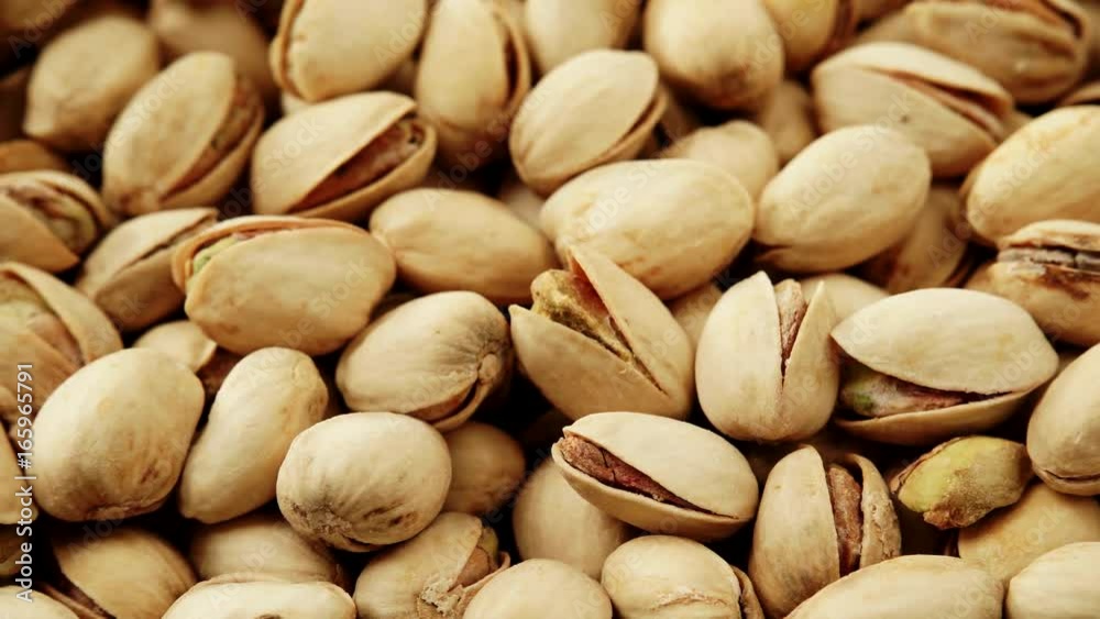 Food background. Roasted pistachio nuts seed with shell close up. Dieting concept. Dolly slider shot 4K ProRes HQ codec Food background. Roasted pistachio nuts seed with shell close up. Dieting concept. Dolly slider shot 4K ProRes HQ codec