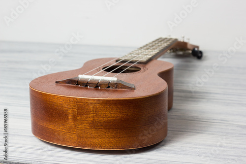 Close up of ukulele on old wooden background photo