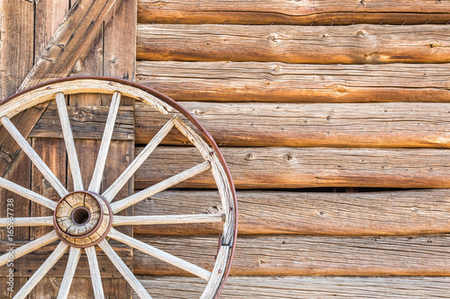 Abstract of Vintage Antique Log Cabin Wall and Wagon Wheel. © Andy Dean