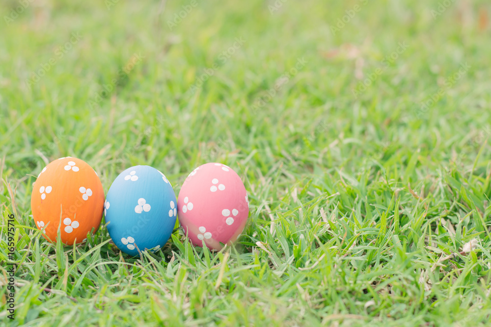 Colorful easter eggs on green grass