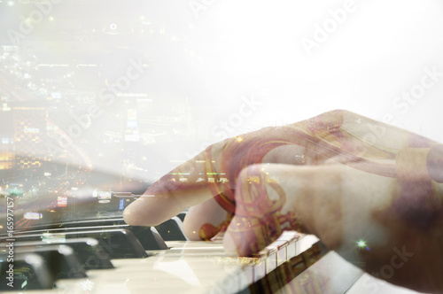 Closeup keyboard of piano with music blur saxophonist background