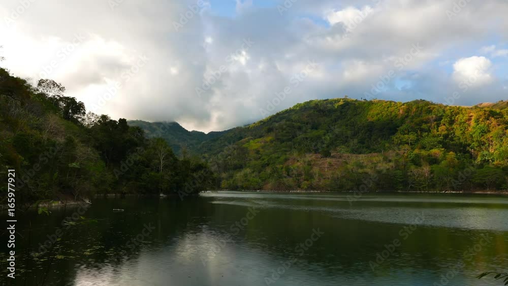 A time lapse video showing the idyllic beauty of the mountain lake Balanan; Negros Oriental, Philippines. Shadows of the clouds can be seen moving over the forests that surround the lake. A time lapse video showing the idyllic beauty of the mountain lake Balanan; Negros Oriental, Philippines. Shadows of the clouds can be seen moving over the forests that surround the lake.