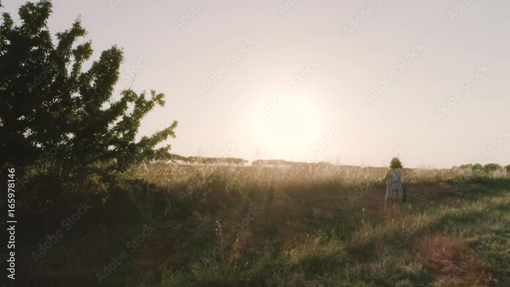 Little Girl Throwing Hat in the Air in open field Little Girl Throwing Hat in the Air in open field