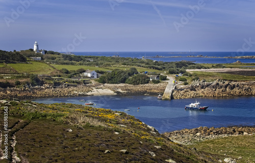 View across to St Agnes from Gugh, with a distant Bishop Rock Lighthouse, Isles of Scilly, Cornwall, England, UK.