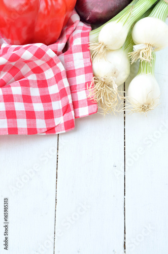 Pepper, onion, spring onion and towel on desks