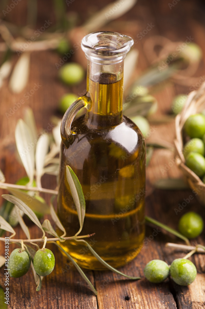Olive oil and olives on wooden rustic table Olive oil and olives on wooden rustic table