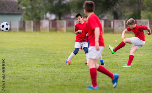 Kids soccer football - children players match on soccer field © Dusan Kostic