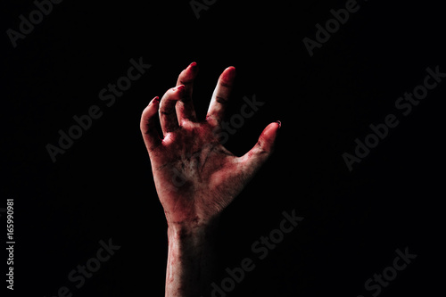 Hand zombie death with blood touching stair on nightmare darkness background, horror halloween festival concept