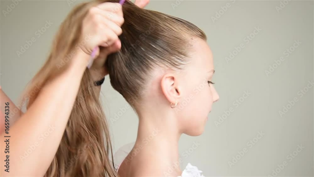 Assistant Does Hairdo For A Young Ballerina. Close Up Assistant Does Hairdo For A Young Ballerina. Close Up