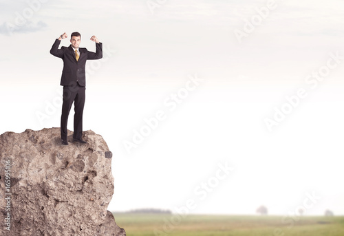 Happy salesman on cliff in the country