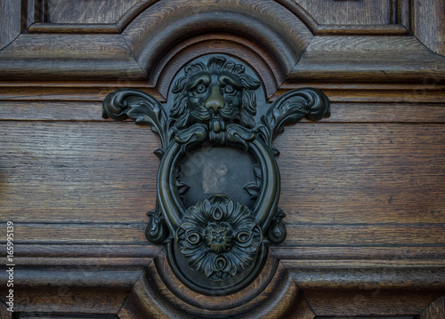 The old door knocker on a wooden door