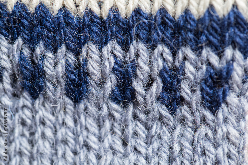 A beautiful closeup of a hand knitted warm and soft wool pattern. Soft socks or scarf of natural wool. Colorful pattern. A beautiful closeup of a hand knitted warm and soft wool pattern. Soft socks or scarf of natural wool. Colorful pattern.