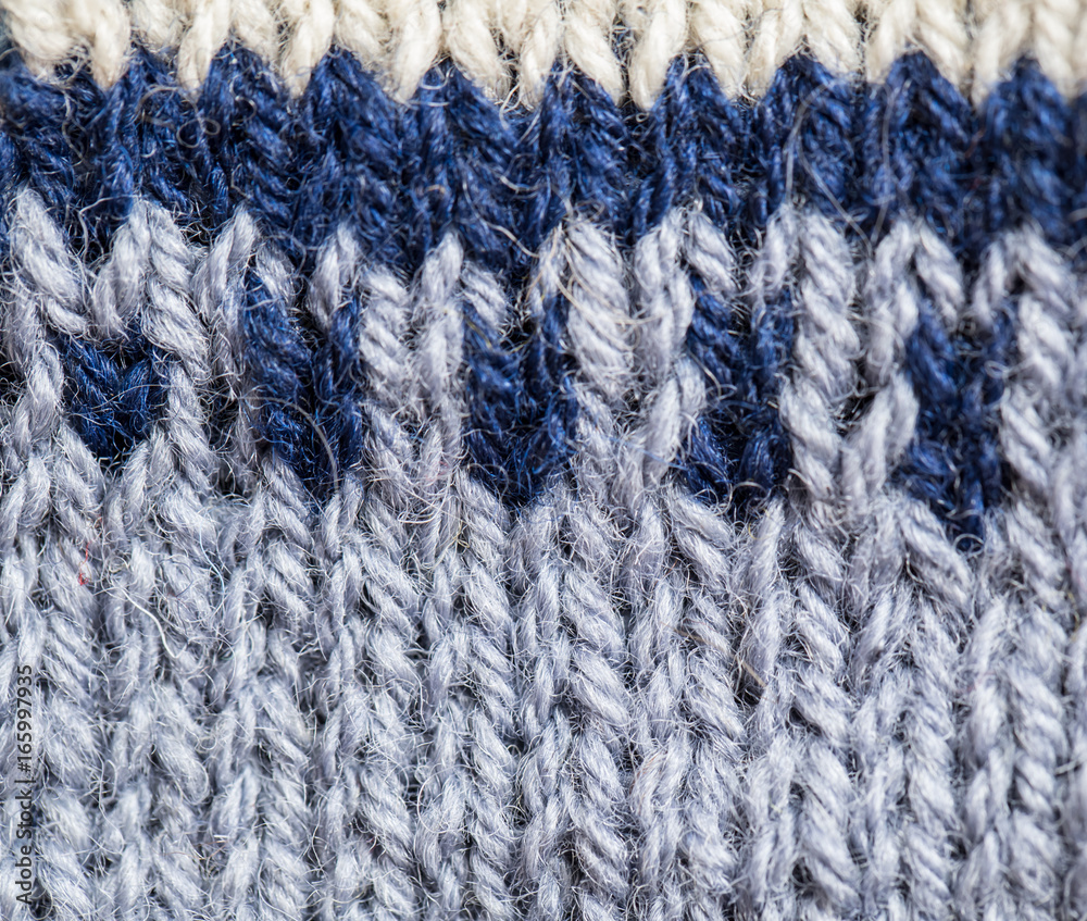 A beautiful closeup of a hand knitted warm and soft wool pattern. Soft socks or scarf of natural wool. Colorful pattern. A beautiful closeup of a hand knitted warm and soft wool pattern. Soft socks or scarf of natural wool. Colorful pattern.