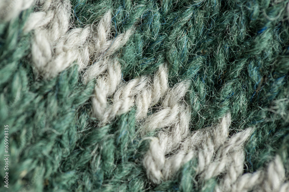 A beautiful closeup of a hand knitted warm and soft wool pattern. Soft socks or scarf of natural wool. Colorful pattern. A beautiful closeup of a hand knitted warm and soft wool pattern. Soft socks or scarf of natural wool. Colorful pattern.