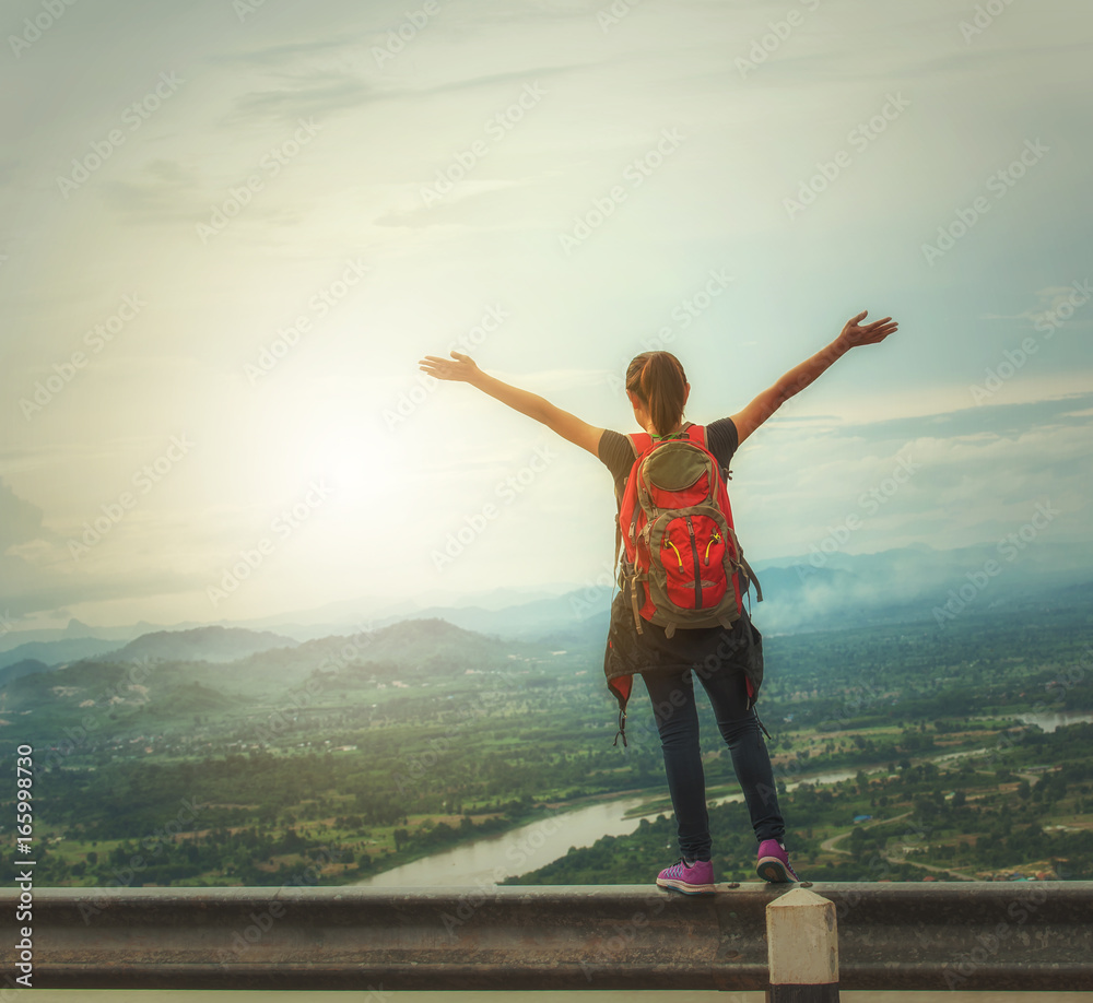 cheering successful woman hiker open arms on mountain top.Young woman enjoying the fresh air. cheering successful woman hiker open arms on mountain top.Young woman enjoying the fresh air.