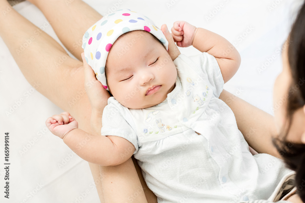 Portrait of adorable baby sleeping on mother leg Portrait of adorable baby sleeping on mother leg