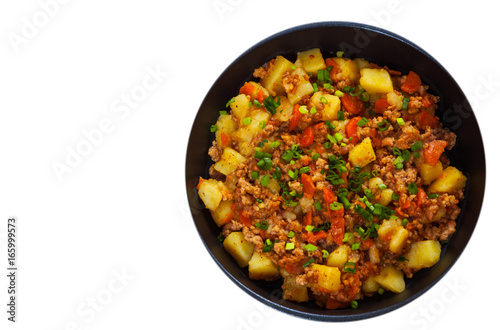 stewed potato with minced meat in a frying pan. top view. isolated on white