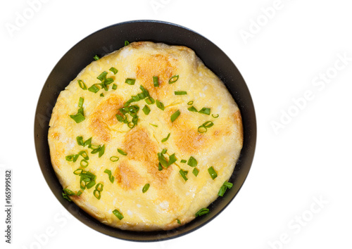 omelet in a frying pan. top view. isolated on white