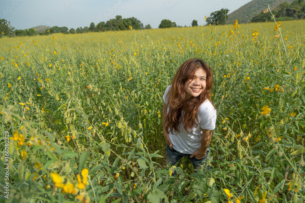 asian women with slightly curly in yellow field at summer, Thailand. asian women with slightly curly in yellow field at summer, Thailand.
