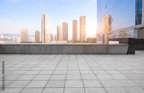 Empty floor with modern skyline and buildings