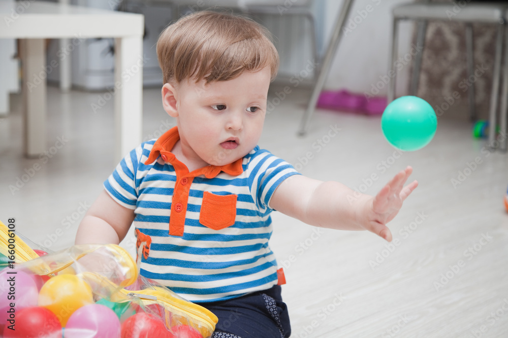 little child playing with colorful balls little child playing with colorful balls