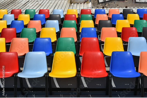 colorful plastic chairs  in rows  horizontal shoot 