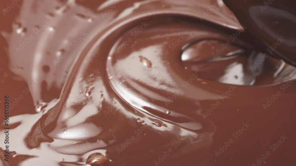 Slow motion stirring premium milk melted chocolate with big spoon Slow motion stirring premium milk melted chocolate with big spoon