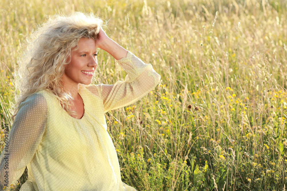 Happy mature woman relaxes in evening sun Happy mature woman relaxes in evening sun
