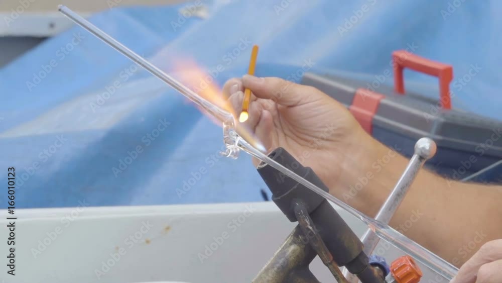 Artist in blowing glass activity. Blown glass by fire to create dog. Glass Blowing. Close up of burner where glass is formed Artist in blowing glass activity. Blown glass by fire to create dog. Glass Blowing. Close up of burner where glass is formed