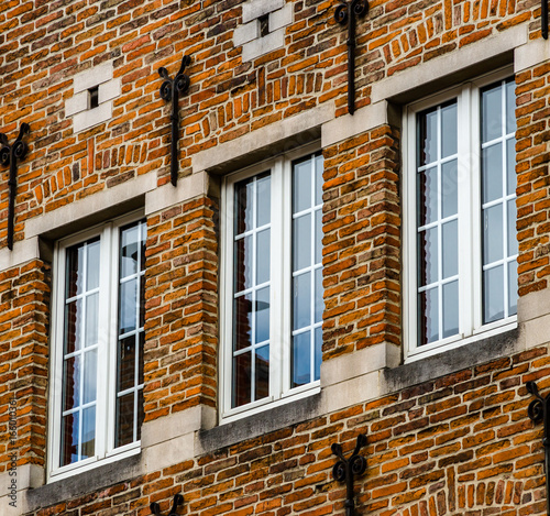 Old but renovated windows in historical part of Bruxelles photo