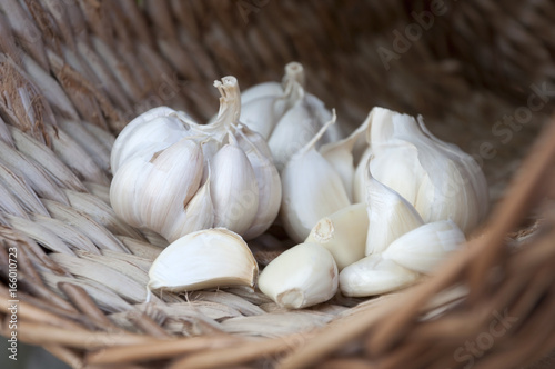 fresh white garlic in a wicker basket