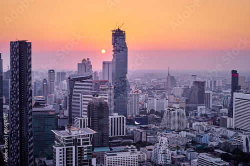Sunset in megapolis. Beautiful cityscape with top view on skyscrapers. Bangkok, Thailand.
