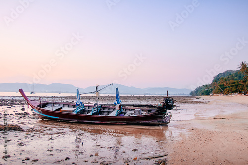 Beautiful sunset on the sea with traditional thai longtail boat.