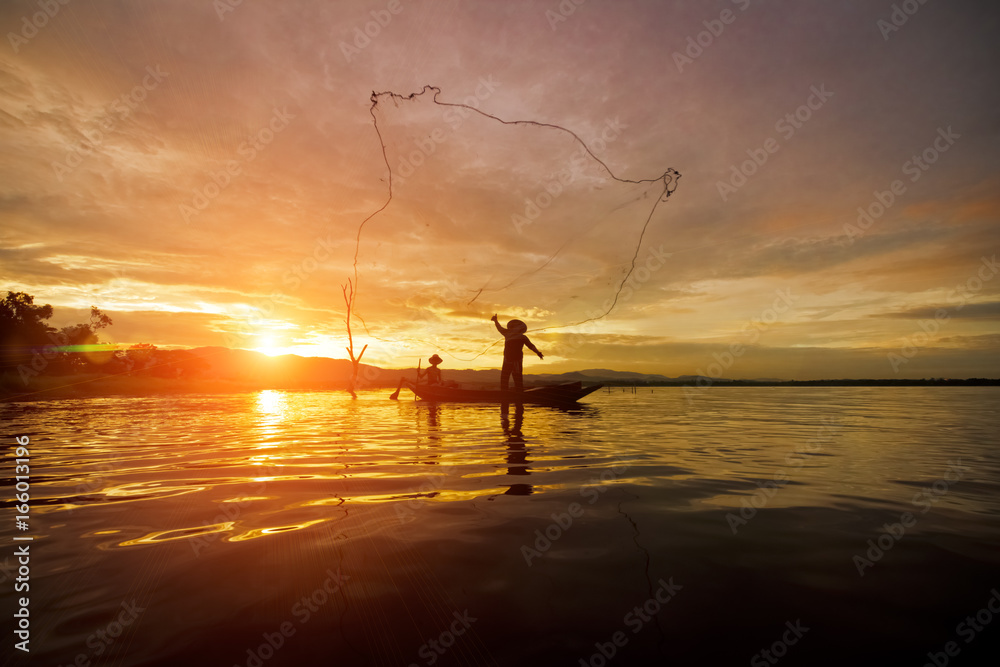Silhouette Fisherman Fishing by using Net on the boat in Thailand