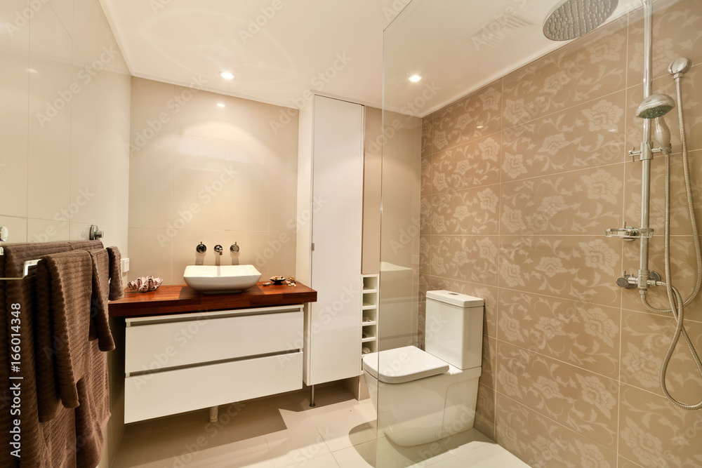 A modern bathroom with a shower area and a bathtub including a wall mirror A modern bathroom with a shower area and a bathtub including a wall mirror
