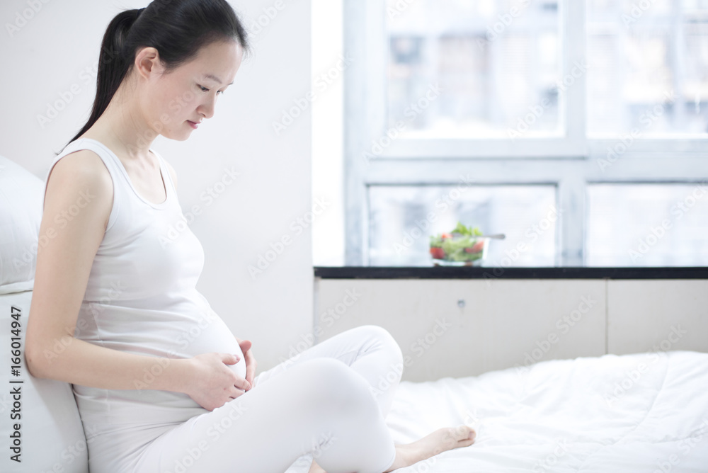 healthy nutrition and pregnancy. pregnant woman's belly and vegetable salad healthy nutrition and pregnancy. pregnant woman's belly and vegetable salad