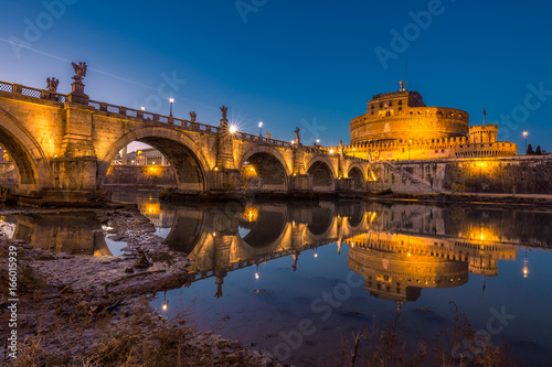 Blue hour view of St. Peters Basilica in the Vatican and the Ponte Sant'Angelo, Bridge of Angels, at the Castel Sant'Angelo and river Tiber in Rome, Italy.