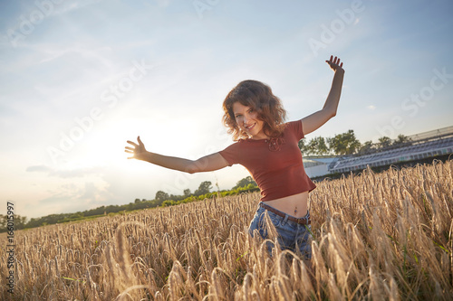 a beautiful woman standing on wheat field