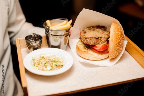 Pepper steak burger with French fries and salad