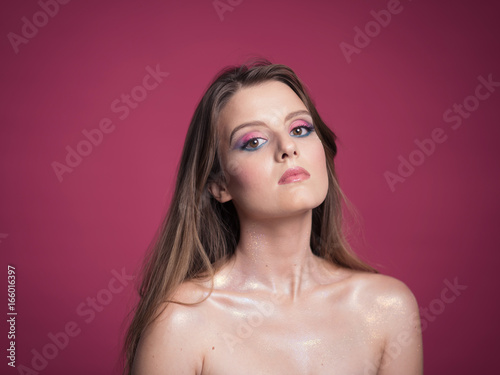 Portrait of beautiful young woman with bright make-up