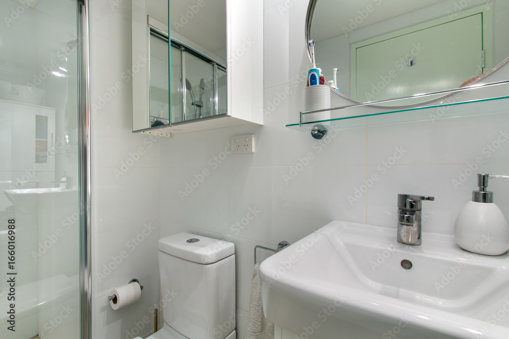 A modern bathroom with a shower area and a bathtub including a wall mirror A modern bathroom with a shower area and a bathtub including a wall mirror