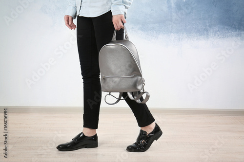 Young woman holding leather...