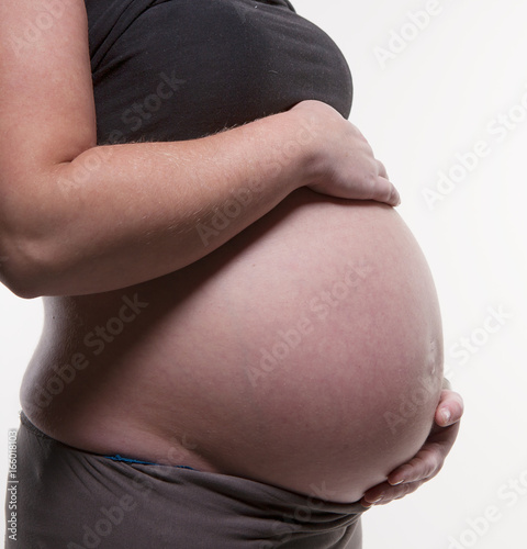 pregnant woman with her hands on her belly photo