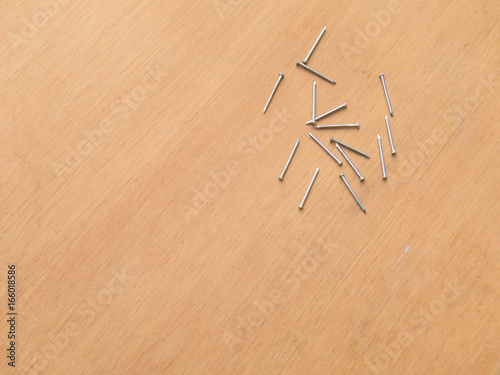 Carpentry material, several new nails on wooden background board