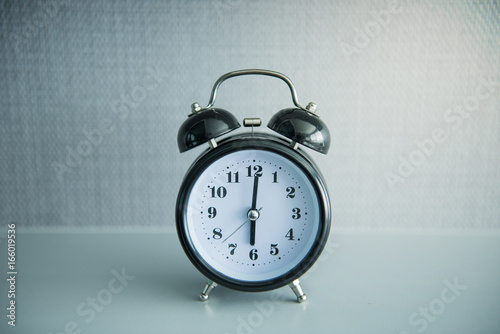 Black alarm clock on 6 O'clock