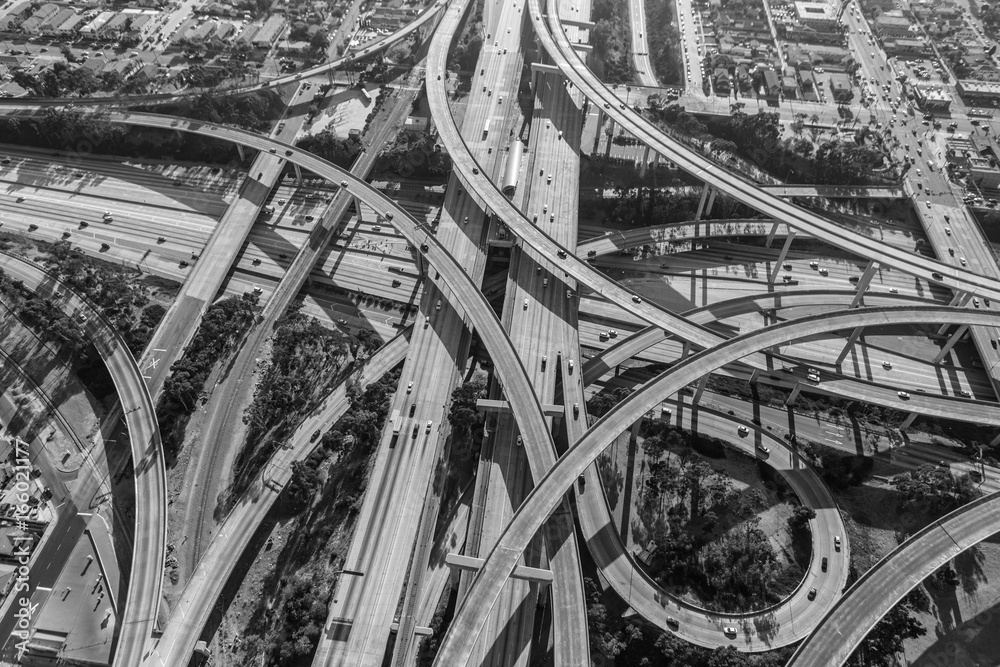 Fototapeta premium Aerial of the Harbor 110 and Century 105 freeway interchange south of downtown Los Angeles in black and white.