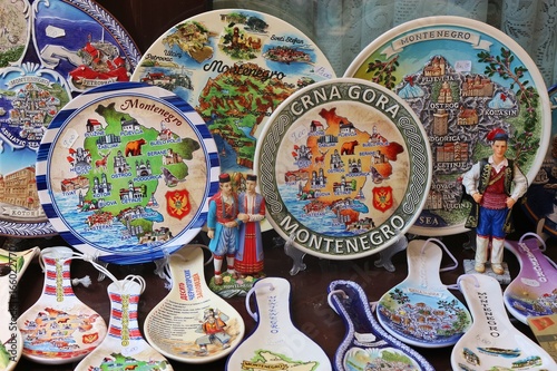 Colorful painted plates and spoons at a souvenir stall in the old city of Bar, Montenegro, Balkan countries, South-Eastern Europe. photo