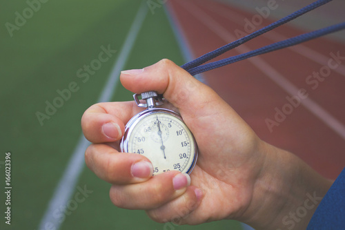 Wallpaper Mural Close up of coach is holding a stopwatch against race track Torontodigital.ca