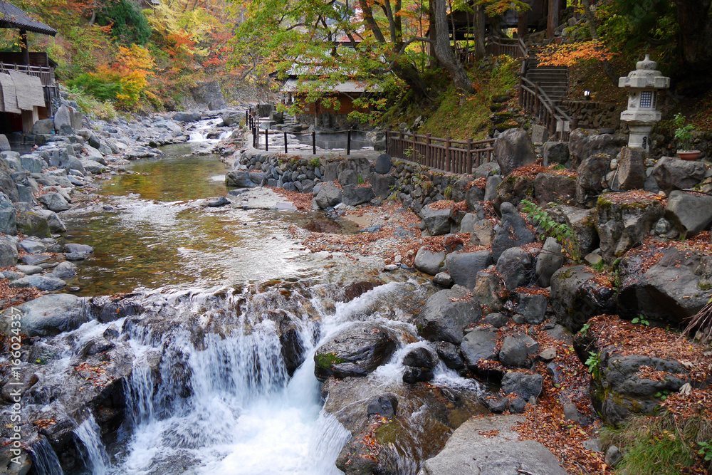 Fototapeta premium Takaragawa onsen hot spring with colorful trees in autumn, Japan