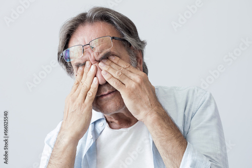Fototapeta Naklejka Na Ścianę i Meble -  Old man with eye fatigue